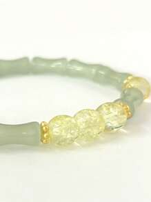 Una pulsera elástica de cuentas transparentes con cadena de bambú articulado, elegante y sofisticada, que simboliza la riqueza y la prosperidad. Adecuada para el uso diario, ocasiones de citas y un regalo pequeño y delicado.