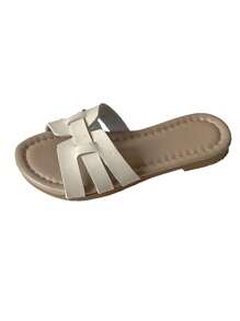 Un par de zapatillas de casa de corte bajo para niñas con tiras tejidas y estampados de patrones de serpiente, con los dedos de los pies expuestos, son simples y versátiles, aptas para uso diario y casual, zapatillas de moda para niños