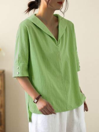 Blusa de unicolor con cuello de Peter Pan, corta por delante y larga por detrás