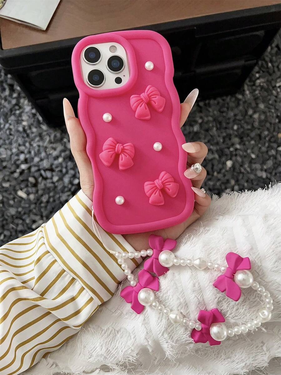 粉色波浪蝴蝶结硅胶大波浪马卡龙手机壳，带腕带，3D仿珍珠装饰，新颖独特，兼容三星Galaxy S25、S24、S24 Plus/S24+、S24 Ultra、S24 FE、S20、S21、S22、S23以及苹果11/11 Pro/11 Pro Max、12/12 Pro/12 Pro Max、13/13 Pro/13 Pro Max、14/14 Pro/14 Pro Max、15/15 Pro/15 Pro Max、16/16 Pro/16 Pro Max、16E。产品特点包括心形握柄、配套挂绳、防震保护、硅胶外壳保护摄像头和屏幕、防水防摔、防刮擦。是女性节日礼物和生日庆祝的理想之选。