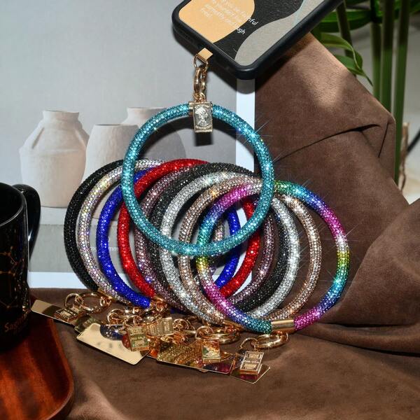 Bracciale con laccetto per telefono completamente tempestato di strass, porta telefono da polso rotondo alla moda e di lusso per le donne, catena da esterno per trasportare il telefono
