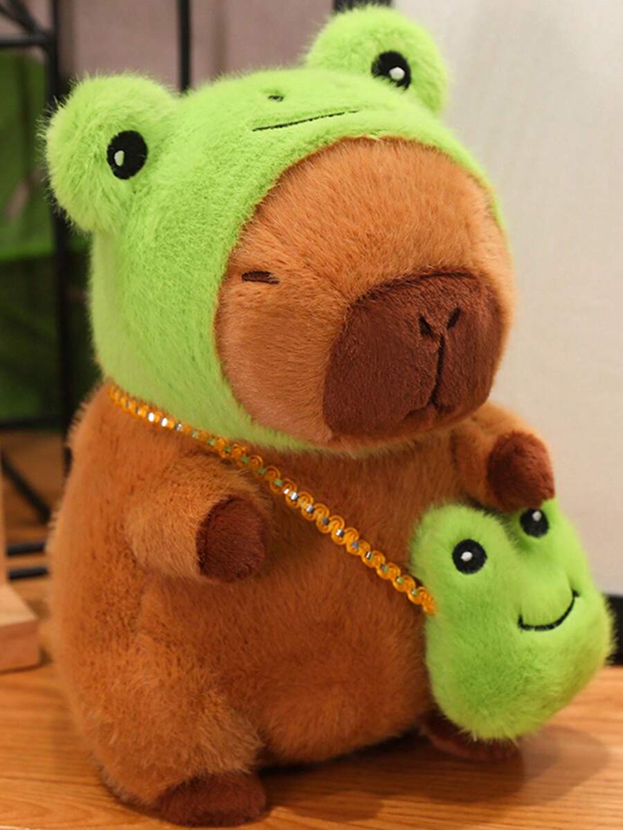 Juguete de peluche adorable de Capibara de 22 cm/8,66 pulgadas con tapa de cabeza de rana y mochila de rana. Estilo de anime de animal de peluche de color marrón oscuro. Regalo perfecto para fans de anime, decoración creativa y regalos para la fiesta de cumpleaños de niños, decoración de habitación de niñas.
