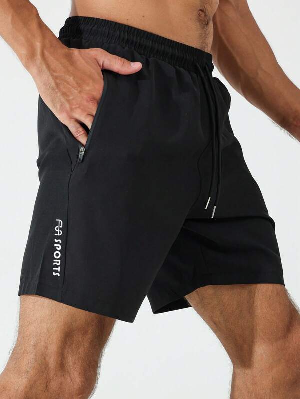 Shorts esportivos elásticos com bolso e zíper e letras gráficas para homens