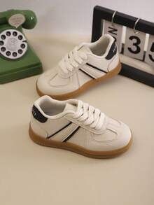 1 par de tênis esportivos infantis de cor sólida com cadarço, sola macia e respirável, tênis casuais adequados para meninos e meninas, corrida ao ar livre, todas as estações