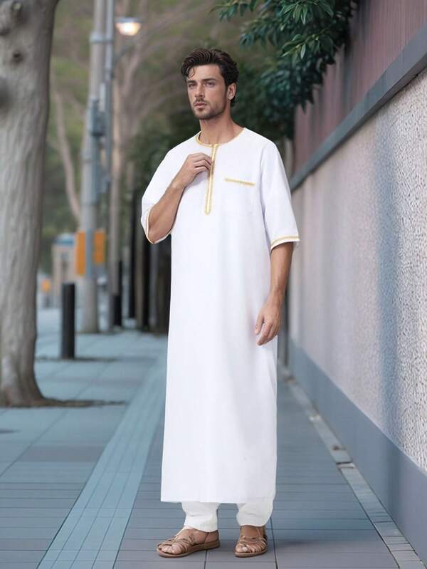 A Long Man's Arabian Robe With A Standing Collar And Pockets Set With Contrasting Gold Edges.