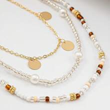 Mehrschichtige bohemische Taille-Kette mit Kunstperle, Pailletten und Metallakzenten für Frauen, charmant und sexy, Reisperlen-Mehrschicht-Pailletten-Bead-Schnur-Taillenkette für Frauen, modischer Strandparty-Style, Körperschmuck im Badeort-Stil