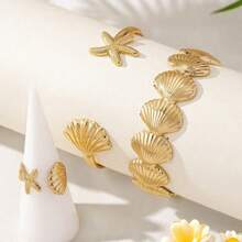 Set de 3 piezas con tema marino, brazalete y anillos abiertos con estrellas de mar y conchas