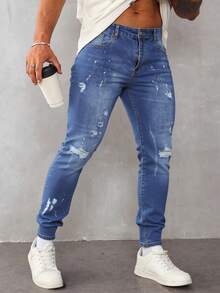 Pantalones vaqueros ajustados para hombre de color azul claro con roturas y detalles de pintura, estilo casual y artístico - Azul lavado medio - Ver 1