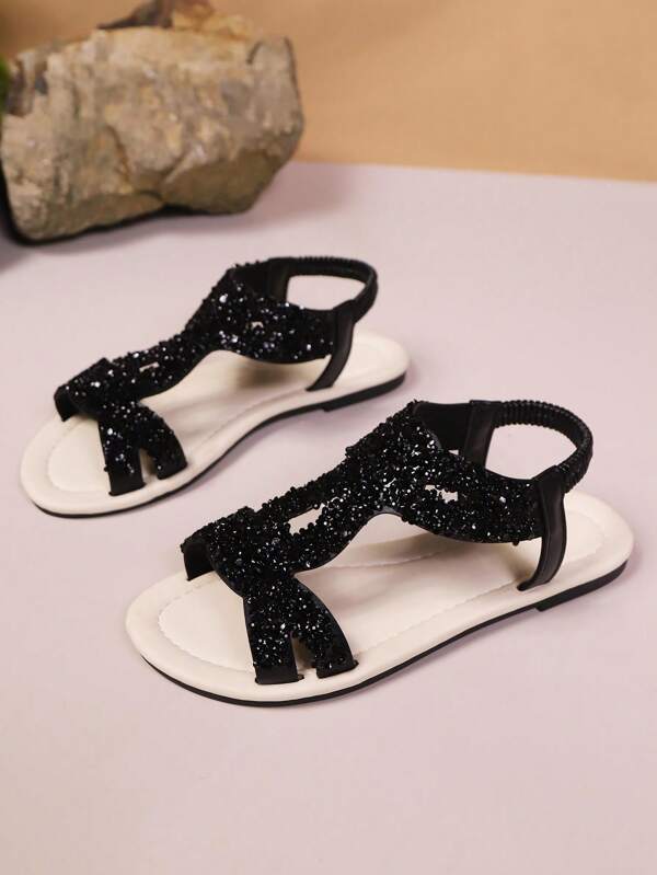 Sandales plates pour femmes ornées de strass et de paillettes, avec sangle élastique à l'arrière. Sandales romaines noires à semelle souple pour l'été