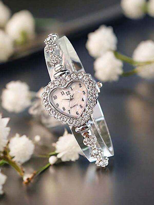 A Stylish Women's Silver Alloy Bracelet With A Heart-Shaped Case, Arabic Numeral Dial, And Delicate Quartz Watch Face. The Adjustable Drawstring Design Makes It Convenient To Wear, Perfect For Everyday Adornment.