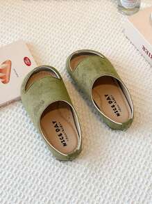Este es un par de chanclas para niños con puntera. El estilo es de una sola pierna y el material de la parte superior parece ser de ante. La suela es gruesa. Este calzado unisex para niños pertenece a la edición coreana minimalista del verano de 2025.