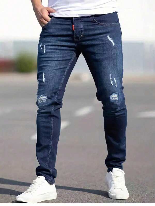 Jeans ajustados de mezclilla elástica desgastados de unicolor para hombre