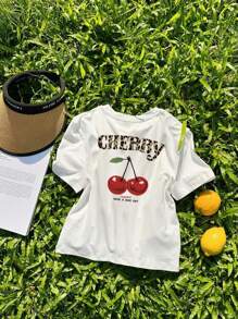 Camiseta de mujer de estilo casual, holgada y versátil con cuello redondo, manga corta, estampado de cerezas y lema, ideal para vacaciones. Camiseta gráfica en color rosa y blanco, adecuada para el uso diario y de vacaciones