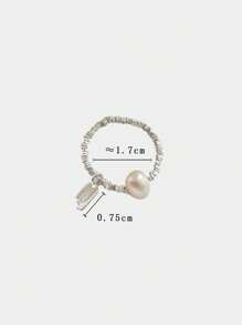 Un anillo de plata pura S925 de perla natural rota para mujeres, con una etiqueta colgante de la suerte y un anillo elástico de cuerda