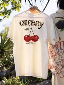 Camiseta de mujer de estilo casual, holgada y versátil con cuello redondo, manga corta, estampado de cerezas y lema, ideal para vacaciones. Camiseta gráfica en color rosa y blanco, adecuada para el uso diario y de vacaciones