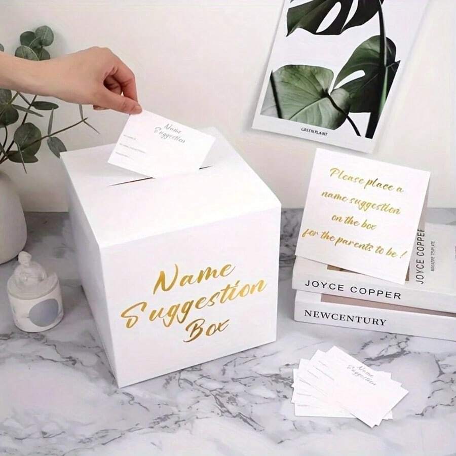 一套金色箔纸姓名建议盒，内含一张展示卡和30张投票卡。非常适合婚礼、迎婴派对、生日、周年纪念日、性别揭晓派对等场合。采用优雅的白色纸张制成。