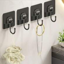 10个黑色自粘墙钩，实用壁挂式自粘挂钩，魔术挂钩，多用途，可用于悬挂衣物、帽子、毛巾、钥匙、杂物等，防水，无需钻孔，安装简便。适用于家庭、浴室、厨房、办公室、酒店等场所，可用于悬挂包包、毛巾、衣物、浴巾等。