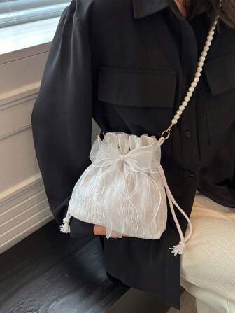 1 件时尚优雅的涤纶面料制成，带有蝴蝶结装饰抽绳开合串珠链肩带女士斜挎包，适合宴会、派对和婚礼