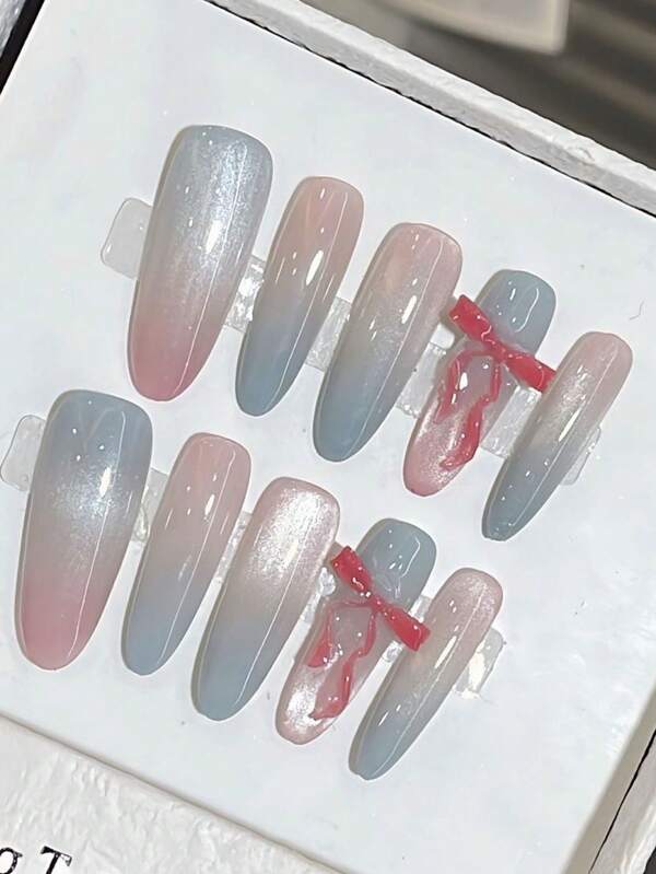 Set Of 10 Long Almond-Shaped Handcrafted Delicate Nail Decorations Featuring Y2K-Style Hand-Painted Gradient Dreamy Pink And Sky Blue Ombre French Cat-Eye Design With A Three-Dimensional Red Ribbon Bow.