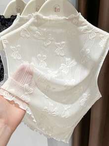 一件女士修身无袖打底衫，波浪形下摆，提花网眼面料，可拆卸领子