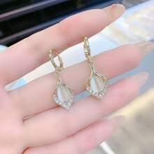 A Pair Of Teardrop Turmeric Petal Cat's Eye Earrings, Exquisitely Crafted, Exudes The Charm Of A Lady And Is A Suitable Jewelry Item For Women To Wear On A Daily Basis