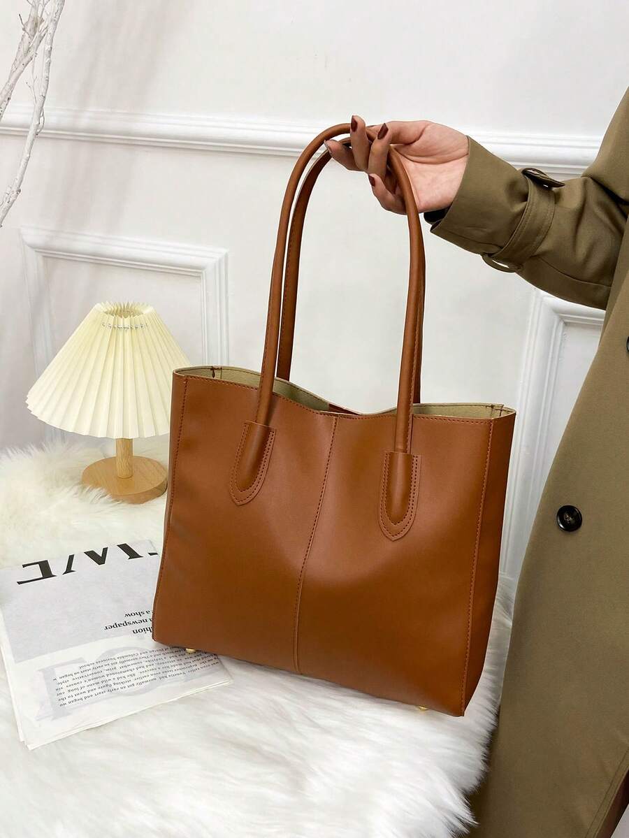 Eine minimalistische und vielseitige Schultertasche mit großem Fassungsvermögen, praktisch für den täglichen Arbeitsweg, Einkaufen, den Unterrichtsbesuch und geeignet für einen akademischen Stil. Sie ist perfekt für alle Jahreszeiten und ideal für Frauen, die ein einfaches und praktisches Design bevorzugen.