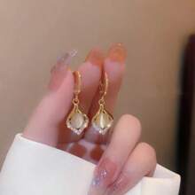 A Pair Of Teardrop Turmeric Petal Cat's Eye Earrings, Exquisitely Crafted, Exudes The Charm Of A Lady And Is A Suitable Jewelry Item For Women To Wear On A Daily Basis