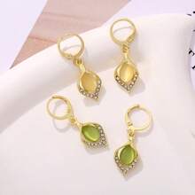 A Pair Of Teardrop Turmeric Petal Cat's Eye Earrings, Exquisitely Crafted, Exudes The Charm Of A Lady And Is A Suitable Jewelry Item For Women To Wear On A Daily Basis