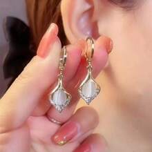 A Pair Of Teardrop Turmeric Petal Cat's Eye Earrings, Exquisitely Crafted, Exudes The Charm Of A Lady And Is A Suitable Jewelry Item For Women To Wear On A Daily Basis