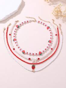 Set de 4 collares con cuentas de perlas con diseños de corazones y fresas para niñas