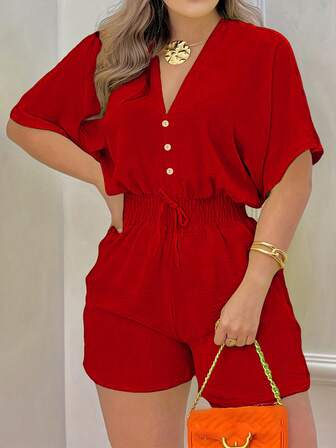 Mono casual de mujer con cuello en V, cintura con botones y lazos, y mangas tipo murciélago
