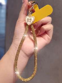 Brazalete tipo cadena de lujo con colgante de lazo y corazón con diamantes de imitación para teléfono móvil