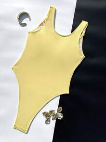Áo tắm liền thân cổ vuông màu trơn dành cho nữ. Được làm từ chất liệu co giãn cao và thân thiện với da, mang lại cảm giác thoải mái khi mặc. Thiết kế cổ vuông đơn giản với dây đeo rộng và nơ trang trí, thiết kế cắt cao ở phần chân giúp kéo dài đôi chân. Tông màu vàng tươi sáng toát lên sức sống, rất phù hợp cho kỳ nghỉ và những buổi đi chơi thường ngày, tạo nên vẻ ngoài tươi mới và tràn đầy năng lượng trên bãi biển. Mùa hè - Màu vàng - Xem 5