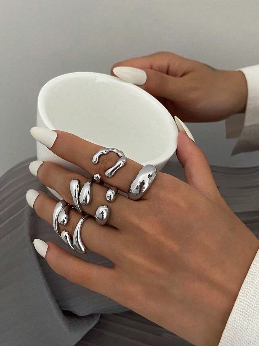 6pcs/Set Vintage Minimalist Alloy Molten Lava Teardrop Design Open Rings, Asymmetrical Fashionable Thick Metal Gold Tone Ring Set, Irregular Drops Of Liquid Metal Drape Over The Ring, Its Surface Replicating The Etched Texture Of Waves, With A Cold Sea Spray Luster On The Electroplated Silver Background. The Glazed Droplets Are Embedded With A Bubble Pattern, A Blue And White Gradient That Resembles The Crashing Waves Of The , And A Crescent-Shaped Indentation Hidden In The Ring's Opening And Closing Points. When The Fingertip Shakes, The Cut Surface Reflects The Shimmering Waves, As If Wearing The Instantly Frozen Waves On The Finger, The Gentle And Rigid Design Allows A Sense Of Niche And A Sense Of Art To Coexist.Suitable For Women's Daily Commute,Perfect Gift For Birthdays, Holiday Gifts, And Parties. Suitable For Daily Wear And Holiday Celebrations, Suitable For All Seasons, And Is An Ideal Choice For Holiday Accessories. - 銀色 - 查看 1