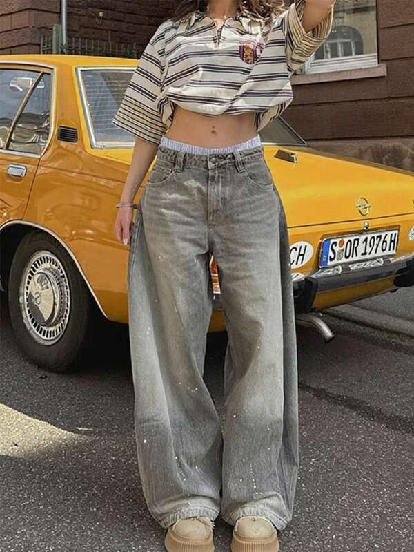 بنطلون جينز واسع الساق بغسيل ممزق من الألم