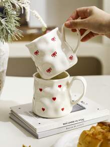 1pc INS Style Large Capacity Ceramic Mug With Bowknot & Heart Design, Handcrafted Asymmetrical Coffee Cup, Suitable For Home Breakfast, Milk, Oatmeal, Garden Afternoon Tea, Latte Art, Juice & Couple Water Cup