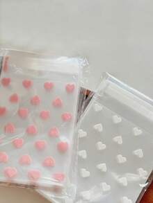 100 个/50 个带有心形图案的自粘塑料袋，耐污，一次性，多用途礼品包装材料 - 非常适合礼物和生日礼物！ - 無色 - 查看 6