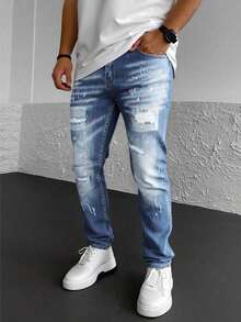 Jeans skinny para hombre en denim azul, con detalles de roturas, desgaste y salpicaduras artísticas, estilo urbano y creativo - Azul lavado medio - Ver 3