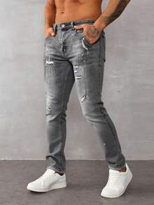 Jeans skinny para hombre en denim gris claro, con detalles rotos y salpicaduras de pintura, estilo urbano y moderno - Gris - Ver 1