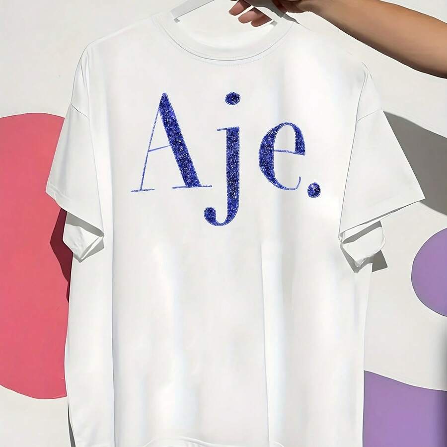 Aje Womens Short Sleeve Crew Neck T Shirt White With Blue Glitter Geometric Graphic Machine Washable Tshirts Casual Attire Smooth Texture Shirt220g Cotton Casual Graphic Lightweight Yet Durable Crew Neck Shirt For Beach Ts, Airplane Travel, Weekend Getaways, Or Road Adventures, Stylish And Comfortable Summer Outfit With Loose Fit For Maximum Comfort, Aesthetic Worthy Graphic For Photos And Reels - trắng - Xem 1