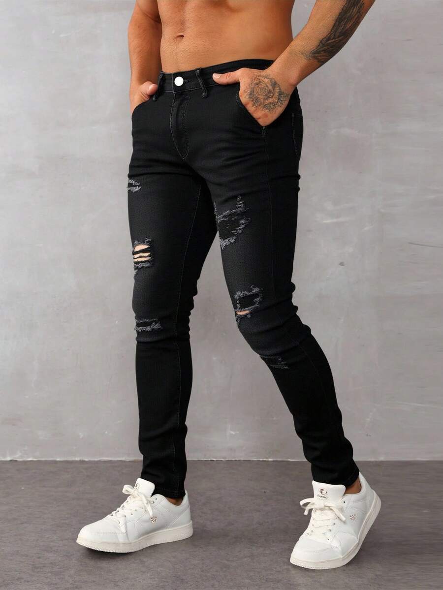 Jeans skinny para hombre en denim negro, con detalles de roturas, estilo urbano y moderno - Negro - Ver 1