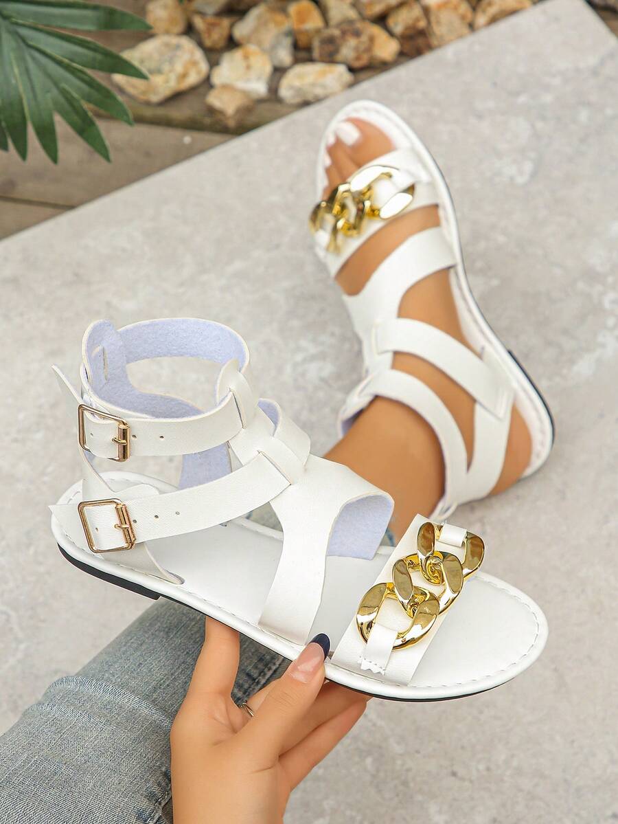 1 双女士纯色露趾罗马风格时尚凉鞋，采用柔软灵活的一体式材料制成，配有踝带扣和金链装饰，打破单调，舒适行走