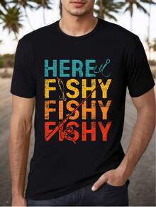 Camiseta de algodón gráfica "Here Fishy Fishy" - Unisex, tejido de punto suave y transpirable, camiseta de cuello redondo de manga corta para hombres y mujeres, ajuste casual, 180g/m² - Perfecta para la playa, fiestas, actividades al aire  entusiastas de la pesca, camiseta de pesca - Negro - Ver 1