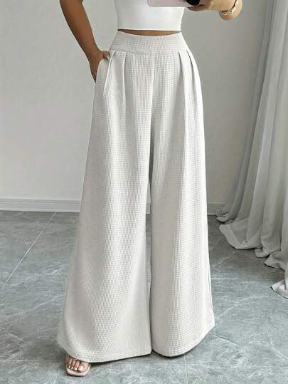 Pantalones rectos y sueltos de mujer con cintura alta, plisados, dunicolordo y con bolsillos