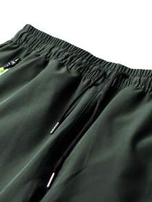 بنطلون رجالي للتنزه في الربيع والخريف مع جيوب سحاب وسحاب، بنطلون مستقيم للركض اليومي مع تسليط الضوء على اللون النيون اللافت