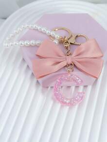 三件套：闪亮粉色洋葱亮片、26个树脂大写英文字母、18K镀金龙虾扣扁环链，搭配时尚粉色布艺蝴蝶结和仿珍珠串珠装饰配件，适用于包包链、手机挂绳、钥匙扣，也可作为礼物送给朋友、母亲、车饰、包包挂饰、背包挂件、带证件夹的挂绳、汽车装饰、圣诞汽车饰品、老师、姐妹等。 - 粉色 - 查看 16