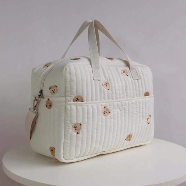 Un joli sac de maman brodé portable, convenant à la fois aux mères et aux bébés, pouvant être porté en travers du corps ou sur une épaule.