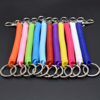 5 kolorowych breloków sprężynowych z linką zabezpieczającą przed zgubieniem, z chowaną smyczą i kółkiem do kluczy z pianki EVA, stylowy dodatek do telefonu i torby, idealny do codziennego noszenia, podróży, biura, na wyjścia, jako prezent na imprezę, wytrzymały i lekki sznurek do bezpiecznego przechowywania kluczy i niezbędnych rzeczy, uniwersalny organizer do portfela, kart, pamięci USB lub małych narzędzi; idealny do szkoły, na siłownię, koncerty, festiwale i imprezy plenerowe; ułatwia przymocowanie do plecaków, torebek, walizek i breloków; jasne, żywe kolory ułatwiające znalezienie i podkreślające styl.