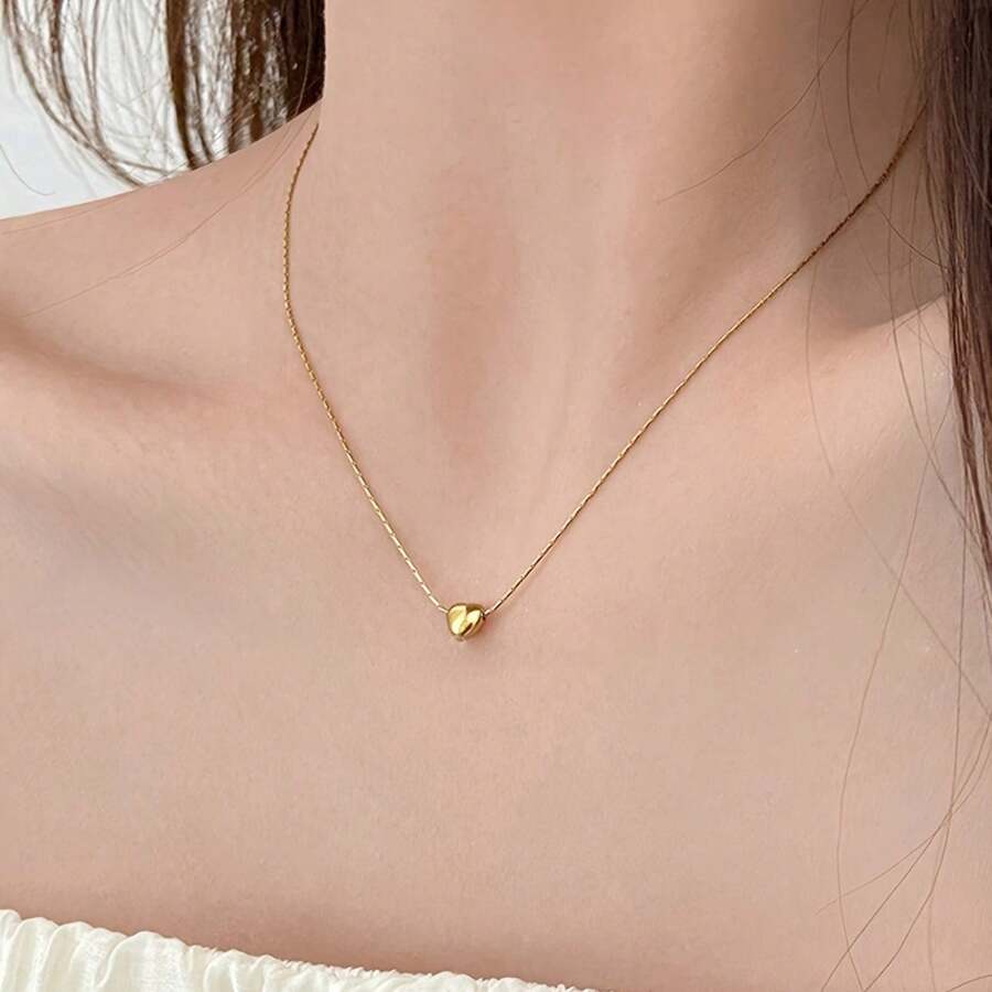 This Small Gold Heart Necklace Holds A Timeless Symbol Of Love. The Delicate Chain, Like A Woven Gold Thread, Seamlessly Fits The Neckline, While The Heart-Shaped Pendant Is Round And Full. ✨ It Gleams With A Delicate Golden Sheen Under The Light, Creating A Simple Yet Sophisticated Feel. Paired With A Shirt, It's A Subtle, Gentle Accent; Paired With A Small Dress, It Accentuates Elegance. Whether It's A Moment Of Solitude Or A Romantic Date, It's Like A Silent Love Message, Expressing Your Heart's Affection. The Material Is Resistant To Oxidation And Won't Fade Or Deform, Allowing You To Preserve This "Little Thought" For A Long Time. Give It To Yourself Or A Loved One, And Let The Fusion Of Gold And Heart Add A Touch Of Sparkle To Every Ordinary Day. ✨ - Vàng - Xem 1