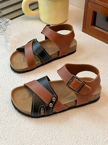 This Is A Pair Of Best-Selling Girls' Sandals. The Upper Is Made Of Brown And Black Leather. The Cross-Strap Design Adds A Sense Of Layering, And It Is Equipped With Metal Buckles To Adjust The Tightness. It Is Convenient To Put On And Take Off. The Upper Layer Of The Sole Is Made Of Cork, Which Fits The Feet Closely And Provides Comfort.